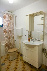 a bathroom with a toilet and a sink at Apartmani Andjelka in Tivat +12 photos