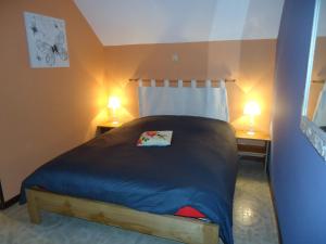 a bedroom with a bed with two lamps on two tables at Villa Clara in La Roche-en-Ardenne +16 photos