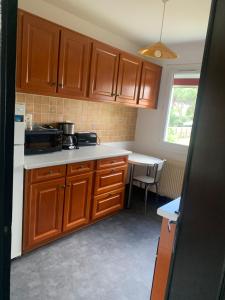a small kitchen with wooden cabinets and a table at maison moderne en face de la mer in Arès +11 photos