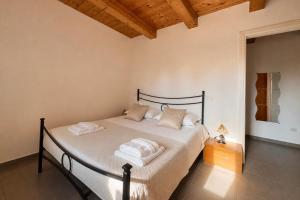 a bedroom with a bed with two towels on it at Agriturismo Il Vecchio Scornabecco in Senigallia