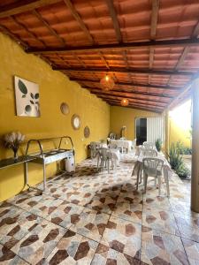 a restaurant with tables and chairs in a room at Casa Dona Vilma in Barreirinhas