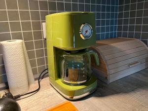 a green coffee maker sitting on top of a counter at Chalupa Lindenberg in Jestrabi V Krkonosich +47 photos