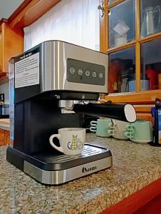 a microwave sitting on a kitchen counter with a coffee maker at Great for Families in Lourinhã-Double Rooms-Private Baths-Free Parking & Extra Bed in Lourinhã