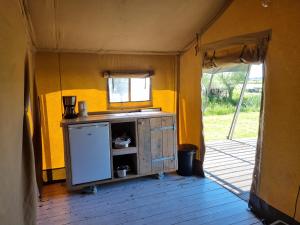 an inside view of a kitchen in a tent at Safaritent Aesgestate in Gauw