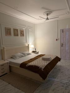 a bedroom with a large bed and a ceiling fan at Aashiyana retreat in Duimukh
