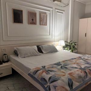 a bedroom with a large bed with a floral blanket at Aashiyana retreat in Duimukh