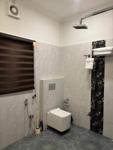 a bathroom with a toilet and a shower at Aashiyana retreat in Duimukh