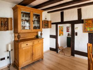 a large wooden cabinet in a room with wooden floors at Ferien im Kellisch-Haus in Schalkenmehren