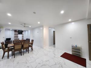 a living room with a dining table and chairs at 77 Fulaga Flats in Suva