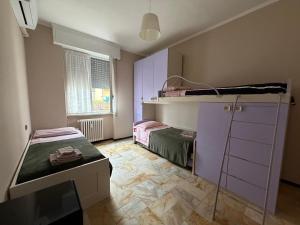 a small room with two bunk beds and a window at SUNNY APARTMENT with big terrace in Rapallo