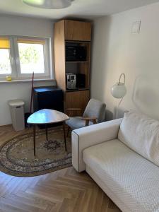 a living room with a couch and a table at Emilówka in Ostrów Wielkopolski