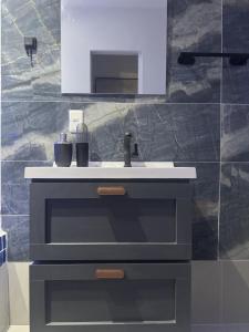 a bathroom with a sink and a mirror at Studio Industrial in Niterói +41 photos