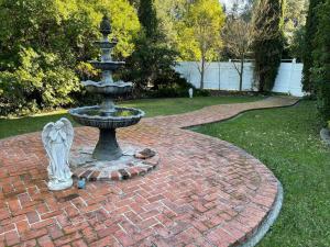 a fountain in the middle of a brick yard at Luxury Private Poolside Suite in Napa