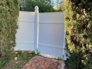 a white privacy fence with a brick driveway at Luxury Private Poolside Suite in Napa