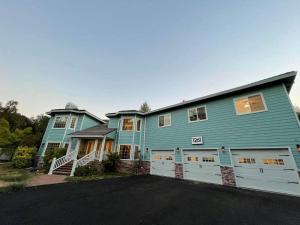 a large blue house with a white garage at Luxury Private Poolside Suite in Napa +32 photos