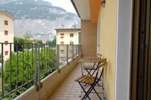 a balcony with two chairs and a table on it at Le Mele - Alle 5 Torri in Mezzolombardo