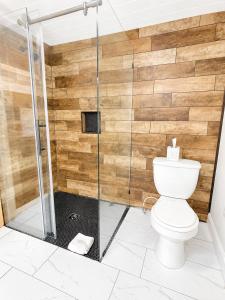 a bathroom with a shower with a toilet at Cottage 12 - King Bed Child Loft w Twin Private Bath Kitchenette Pets Allowed Fee applies in Wolfeboro