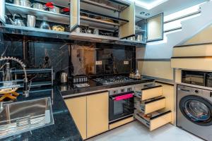 a kitchen with a stove and a dishwasher at Villa America Dakhla in Dakhla