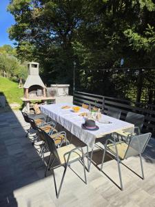 a table with chairs and a white table and a grill at Forest Magic in Duga Resa +33 photos