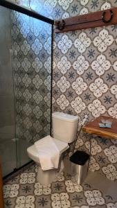 a bathroom with a toilet and a shower at The Barn Experience - Mantiqueira in Sylvestre Ferraz