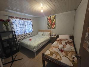 a bedroom with two beds and a window at G&A Friendly stay in Port Vila