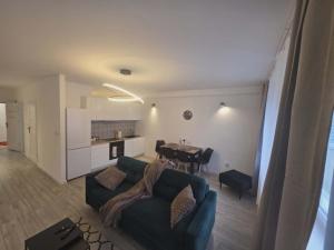 a living room with a couch and a table at Apartament Anny 1 in Grodzisk Mazowiecki
