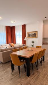 a living room with a table and chairs and a couch at Brickstone Apartments Malbork in Malbork