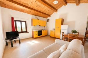 a living room with a couch and a table at Agriturismo Il Vecchio Scornabecco in Senigallia +18 photos