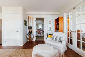 a living room with a white couch and a chair at The Perch at Eagle Harbor in Bainbridge Island