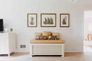 a white room with a bench with pillows on it at The Perch at Eagle Harbor in Bainbridge Island