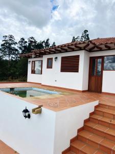 a house with a swimming pool in front of it at Casa Silvestre in Villa de Leyva