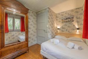 a bedroom with a large white bed and a window at Chalet Ecureuil Family retreat w/ Garden & Fireplace - Happy Rentals in Chamonix