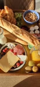 a tray of cheese and other foods on a table at Ardennes Prestige Glamping in La Neuville-aux-Joûtes