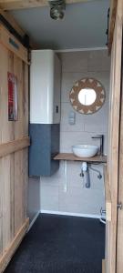 a small bathroom with a sink and a mirror at Ardennes Prestige Glamping in La Neuville-aux-Joûtes