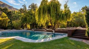 a swimming pool in a yard with trees at Casa Bosque Lodge in San José de Maipo