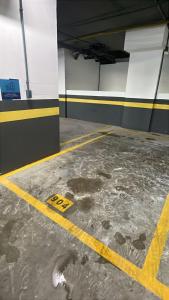 a parking garage with a yellow line on the floor at SkyHero Apê in Vila Velha