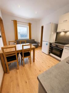 a kitchen and living room with a table and chairs at M3-Apartmány in Martin +22 photos