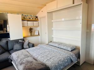 a bedroom with a bed and a couch at VRBNIK OLD CITY LOFT in Vrbnik