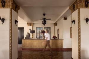 a person walking through a room in a building at The Faust Hotel in New Braunfels