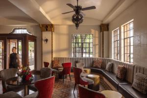 a lobby with a couch and chairs and windows at The Faust Hotel in New Braunfels +36 photos