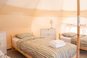 a bedroom with two beds in a tent at Glamping Stolat in Stolat +65 photos