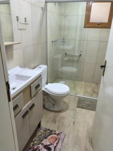 a bathroom with a toilet and a shower and a sink at Pousada Relicário in Nova Petrópolis +31 photos