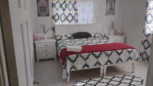 a bedroom with a bed with a red blanket at Irie Bamboo in Bamboo