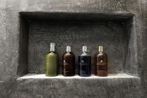 three bottles sitting on a shelf in a wall at Lontos Luxury Seaside House in Flampouria
