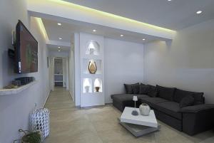 a living room with a couch and a table at Lontos Luxury Seaside House in Flampouria
