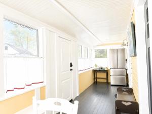 a kitchen with a white door and a refrigerator at Cottage 8-9 - Stand Alone 2 Bedroom 2 Bath Private Courtyard Pet Friendly with Fee in Wolfeboro