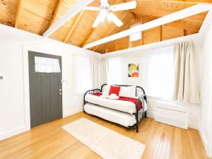 a bedroom with a bed and a ceiling fan at Cottage 8-9 - Stand Alone 2 Bedroom 2 Bath Private Courtyard Pet Friendly with Fee in Wolfeboro