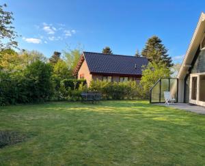 a yard with a house and a patio at Utpuster in Lauwersoog +7 photos