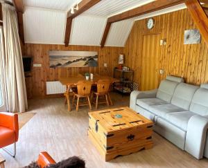 a living room with a couch and a table at Utpuster in Lauwersoog