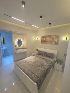 a bedroom with a bed and a mirror on the wall at Prime Plaza Porto Towers Stay Hotel VIP in Ain Sokhna +124 photos